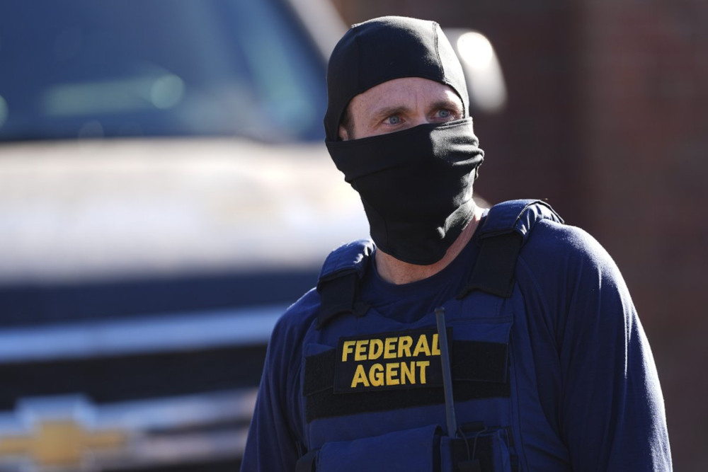 ICE agent with mask from Newsweek
